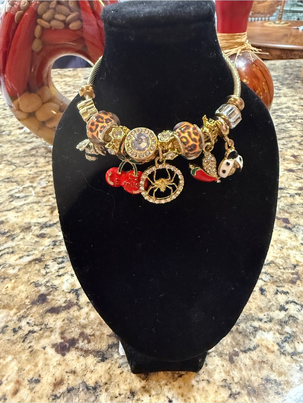 Gold Charm Statement bracelet with Leopard Beads and Red Accents